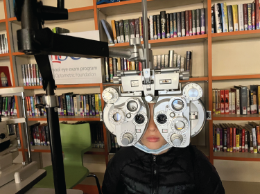 student sitting in eye care chair